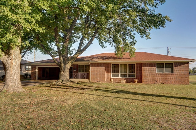 rear view of property featuring a lawn