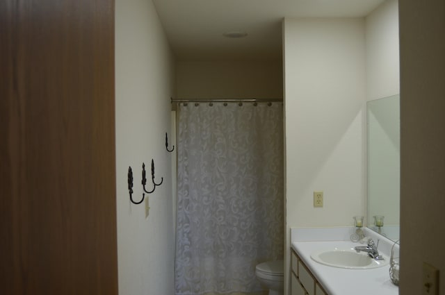 bathroom with vanity, toilet, and curtained shower