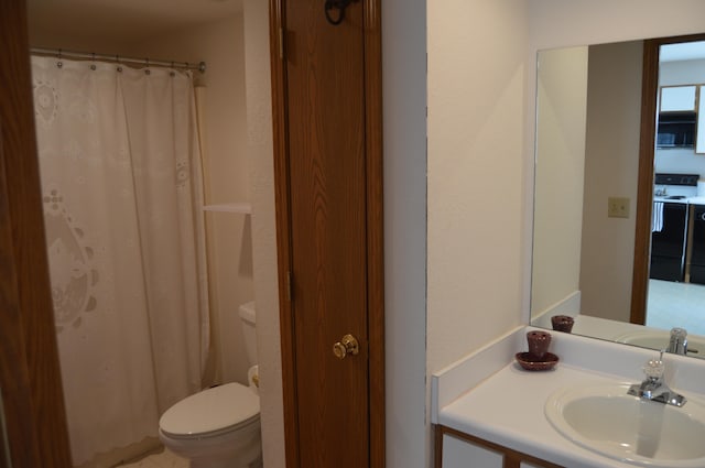 bathroom featuring walk in shower, vanity, and toilet