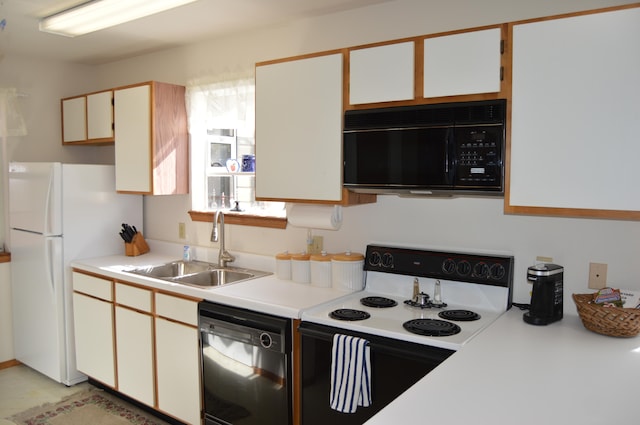 kitchen with white cabinets, black appliances, and sink