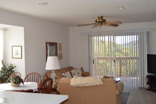 living room featuring ceiling fan and a healthy amount of sunlight