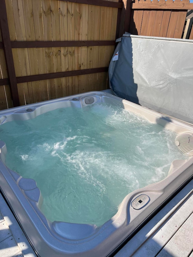 view of swimming pool with a covered hot tub