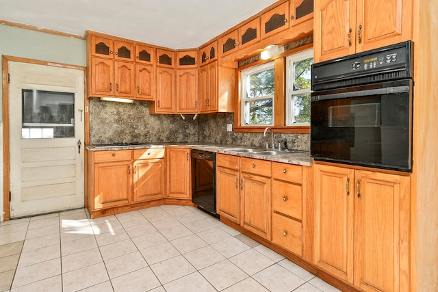 kitchen featuring light tile patterned flooring, black appliances, sink, and tasteful backsplash