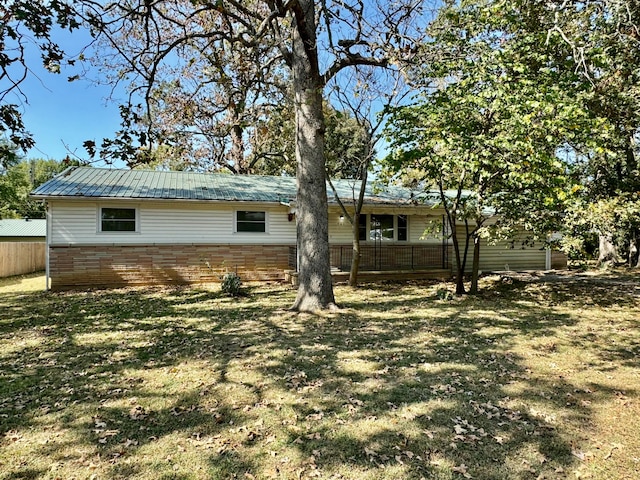 rear view of property with a yard