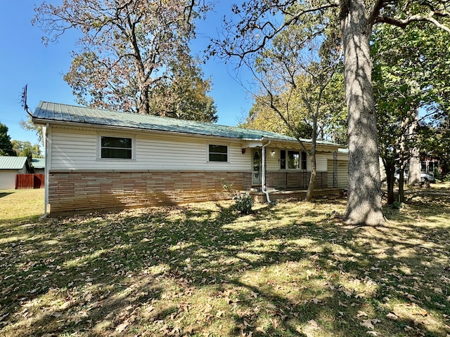 rear view of house with a yard