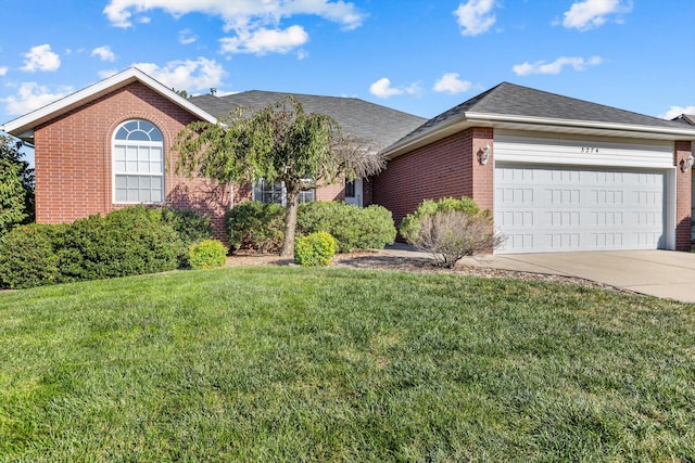 ranch-style house featuring a garage and a front lawn