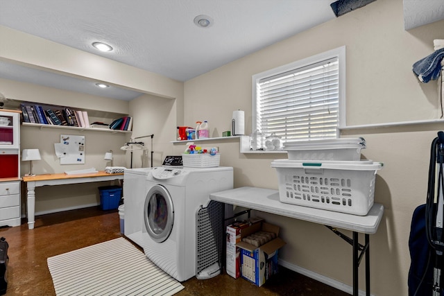 laundry room with washing machine and dryer and a textured ceiling