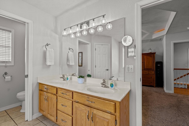 bathroom featuring tile patterned floors, vanity, and toilet