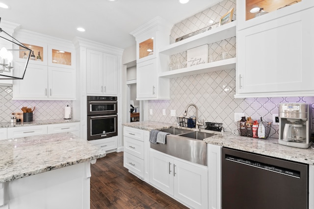 kitchen featuring dishwashing machine, stainless steel double oven, dark wood-type flooring, white cabinetry, and decorative light fixtures