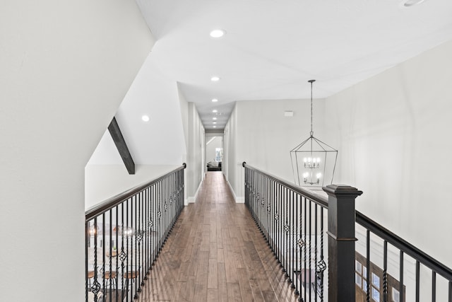 hall featuring an inviting chandelier, beam ceiling, and dark wood-type flooring