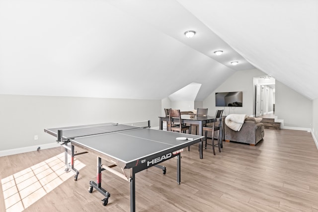 recreation room with light wood-type flooring and lofted ceiling