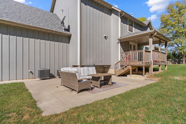 rear view of house with a patio, a yard, an outdoor living space, and cooling unit