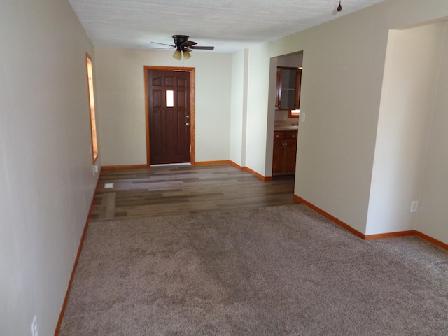 entryway featuring wood-type flooring, a textured ceiling, and ceiling fan