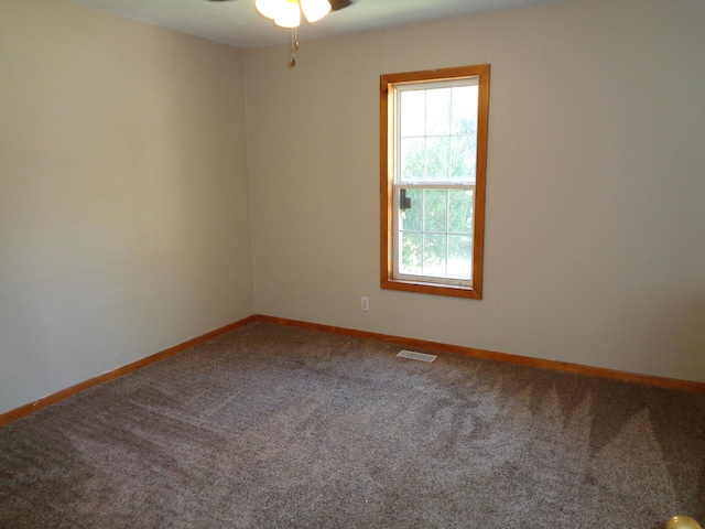 carpeted empty room featuring ceiling fan