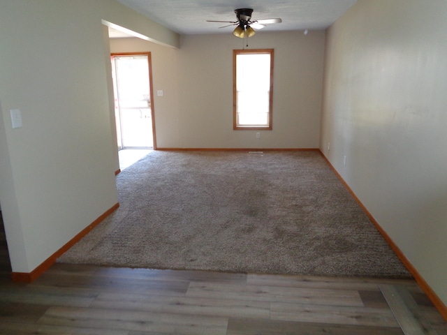 spare room featuring ceiling fan, plenty of natural light, and light hardwood / wood-style flooring