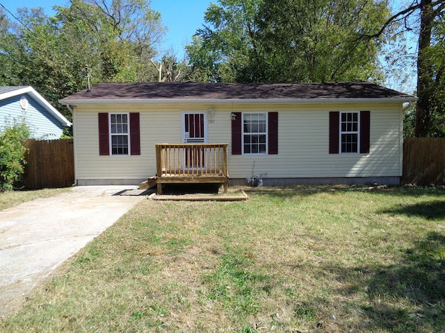 ranch-style house featuring a front yard and a deck