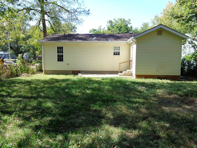 back of house with a patio area and a lawn