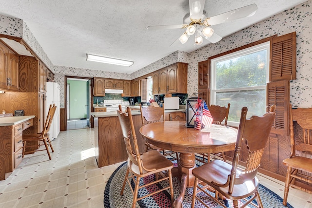 1400 W Oak St, Ozark, MO 65721 - dining space with light floors, wallpapered walls, a textured ceiling, and ceiling fan