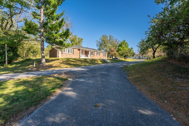 1400 W Oak St, Ozark, MO 65721 - view of front of home featuring driveway, brick siding, and a front yard