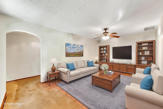 1400 W Oak St, Ozark, MO 65721 - living area featuring arched walkways, baseboards, visible vents, built in shelves, and ceiling fan