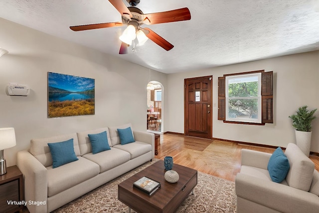 1400 W Oak St, Ozark, MO 65721 - living area with arched walkways, light wood-style flooring, a textured ceiling, and baseboards