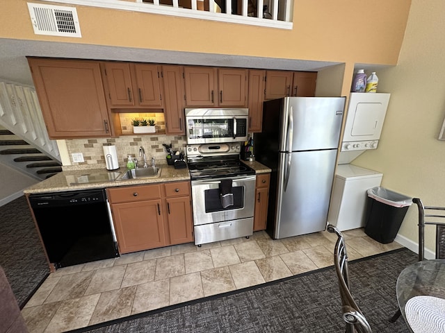 420 Fall Creek Dr Unit 6, Branson, MO 65616 - kitchen with stacked washer / dryer, stainless steel appliances, backsplash, visible vents, and a sink
