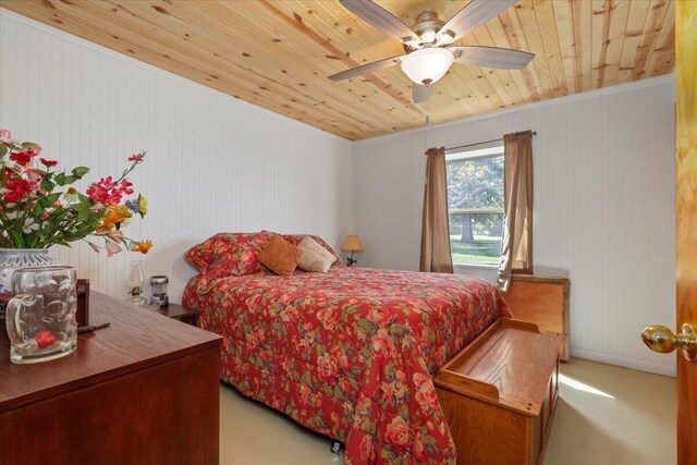 carpeted bedroom featuring ceiling fan, wood ceiling, and ornamental molding