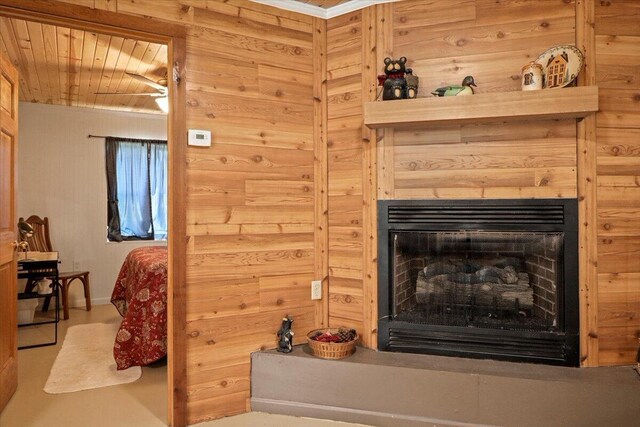 interior details featuring wooden ceiling, wood walls, and a fireplace