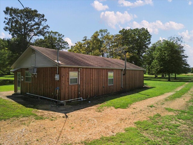 view of side of property with board and batten siding and a yard