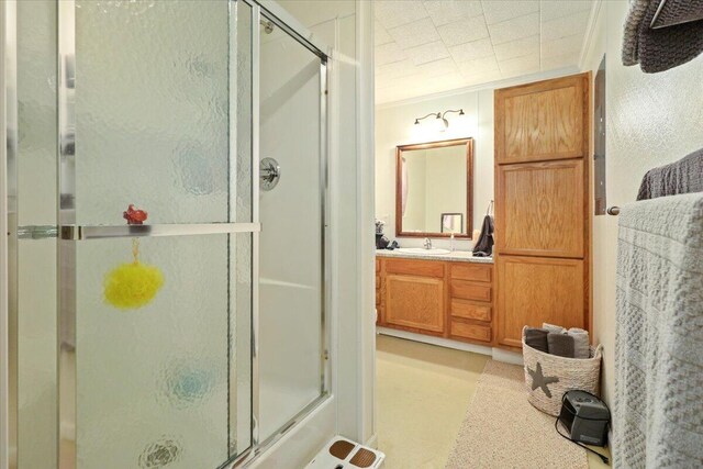 full bath with a shower stall and vanity