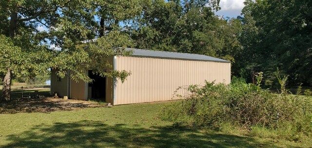 view of pole building with a yard