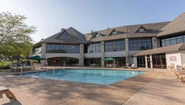 view of swimming pool with a patio