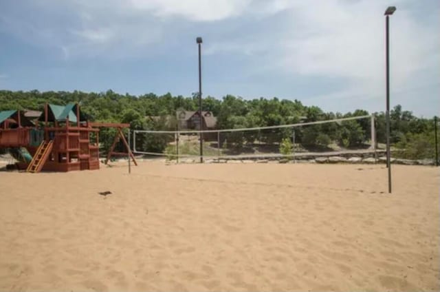 view of home's community featuring volleyball court and a playground