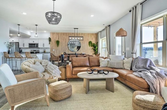 living room featuring light wood-type flooring and a chandelier