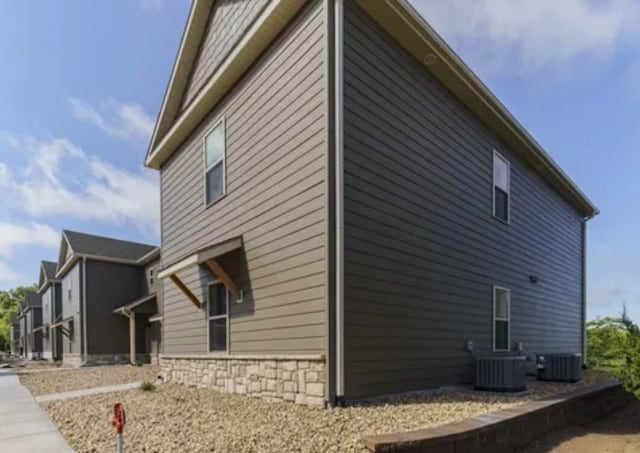 view of side of property featuring central AC