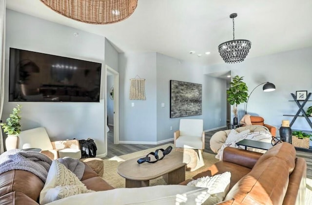 living room featuring an inviting chandelier and light wood-type flooring