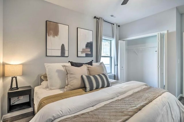 bedroom with a closet, hardwood / wood-style flooring, and ceiling fan