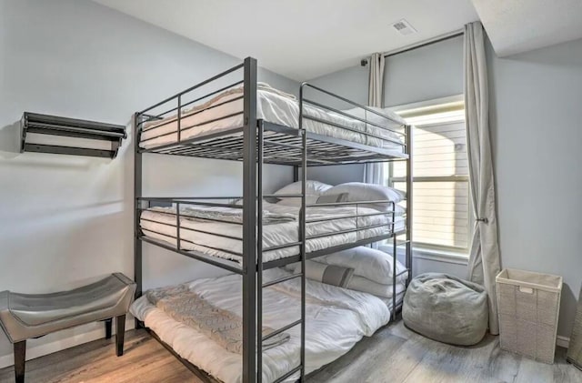 bedroom with wood-type flooring