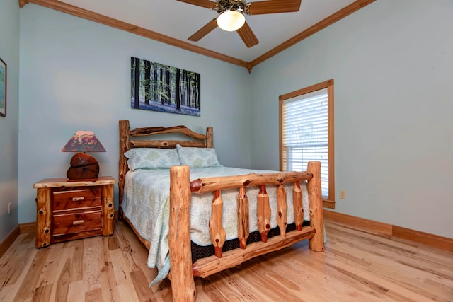 bedroom featuring light wood-type flooring, crown molding, and ceiling fan