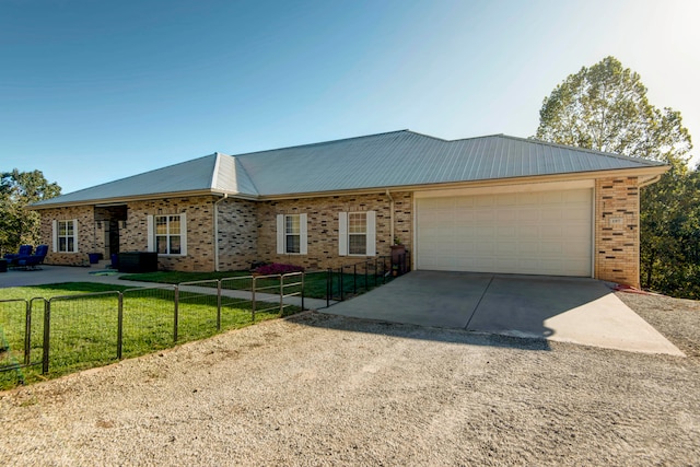 single story home featuring a garage and a front yard