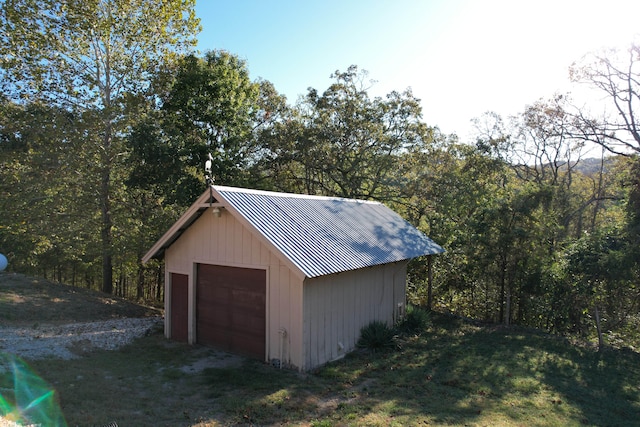 garage with wood walls and a yard