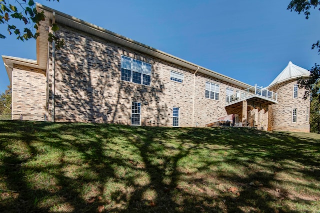 rear view of house featuring a lawn