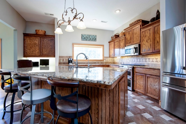 kitchen featuring sink, decorative light fixtures, backsplash, a chandelier, and stainless steel appliances