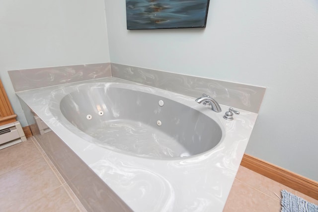 bathroom featuring a tub to relax in, tile patterned flooring, and baseboard heating