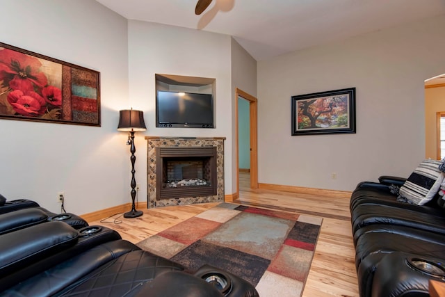 living room with wood-type flooring, a fireplace, and ceiling fan