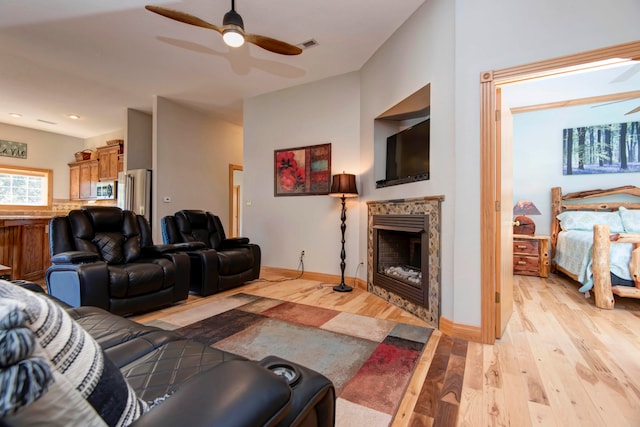 living room featuring light wood-type flooring and ceiling fan