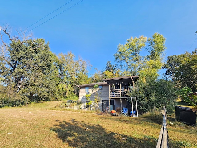 rear view of house featuring a lawn