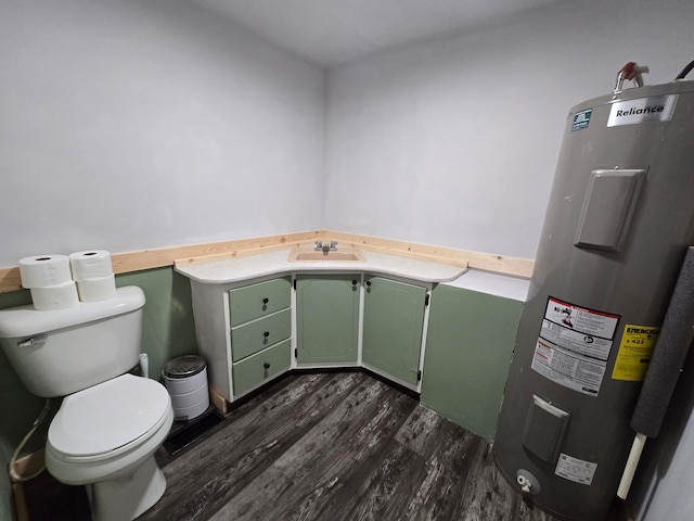 bathroom featuring vanity, water heater, toilet, and hardwood / wood-style flooring