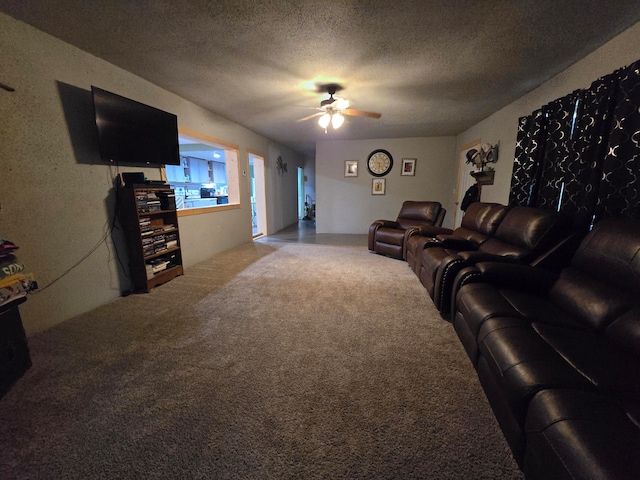 living room with ceiling fan, carpet floors, and a textured ceiling