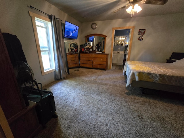 carpeted bedroom featuring ceiling fan, ensuite bath, and multiple windows